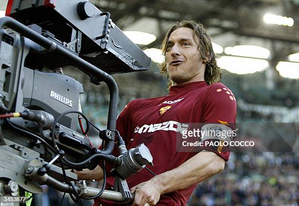Roma's captain Francesco Totti celebrates with a tv camera after scoring against Lazio during their Serie A soccer match at Rome's Olympic stadium 21...