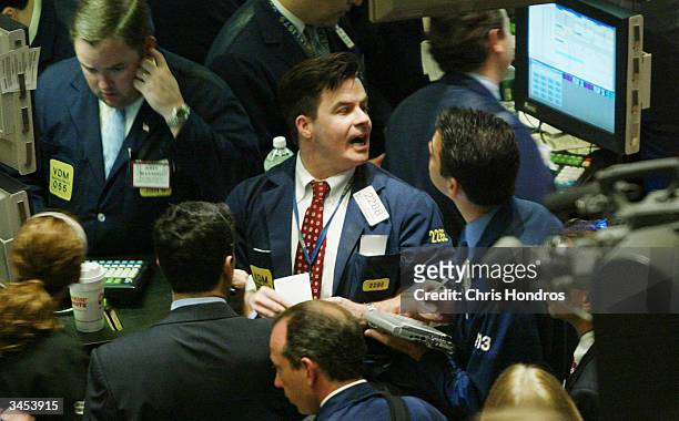 Trader shouts on the floor the New York Stock Exchange April 21, 2004 in New York. Stocks were mixed in the first hour of trading as interest rate...