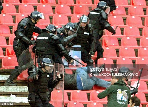 Serbian riot police clash with soccer fans during the National Cup semi final match Red Star vs Partizan in Belgrade 21 April 2004. Red Star won 1:0....