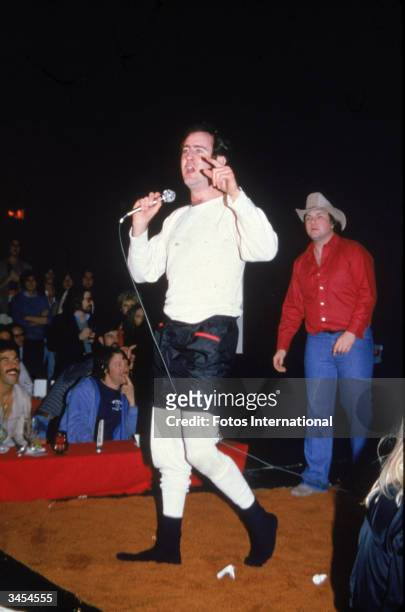 American comedian Andy Kaufman gestures while performing his wrestling act at The Comedy Store nightclub, December 1979.