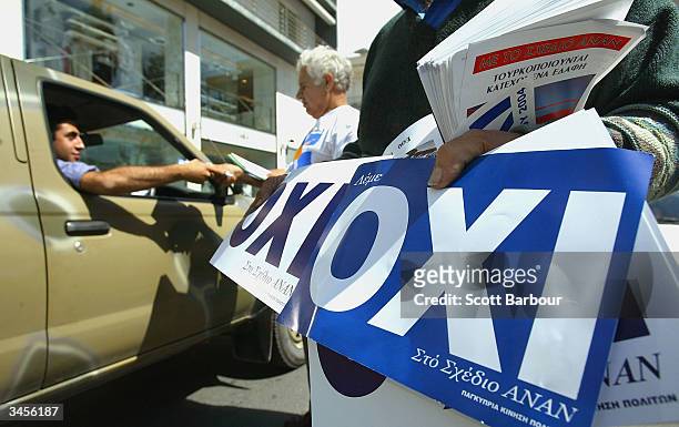 Greek Cypriots hand out 'OXI' or 'NO' leaflets to drivers stuck in traffic, on April 22, 2004 in Limassol, Cyprus. Cypriots will vote this weekend in...