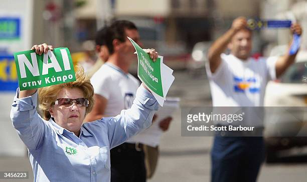 And 'NO' supporters hand out leaflets to passing motorists, on April 22, 2004 in Limassol, Cyprus. Cypriots will vote this weekend in a referendum on...