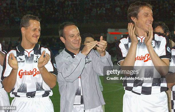 Ferrari Formula One drivers Michael Schumacher of Germany and Rubens Barrichello of Brazil and the son of Ferrari chief Luca Cordero di Montezemolo...