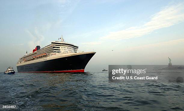 In this U.S. Coast Guard handout, the Queen Mary II, the largest cruise ship in the world, makes her way past the Statue of Liberty on her maiden...