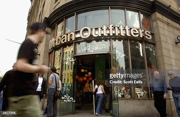 Pedestrians pass in front of "Urban Outfitters" on 6th Ave. And 14th street in Manhattan. Urban Outfitters, due to popular demand and high stock...