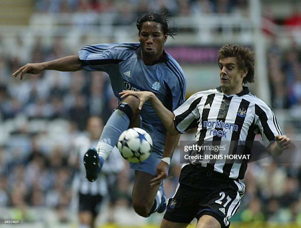 Marseille's Didier Drogba (L) and Newcas