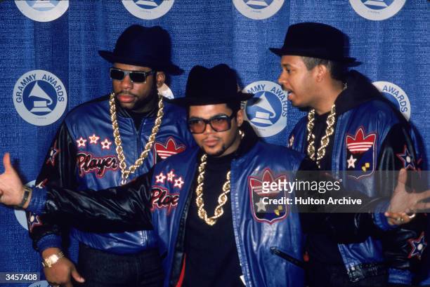 Portrait of American hip-hop and rap group Run-DMC backstage at the Grammy Awards, New York, New York, March 2, 1987. Left to right, Joe Simmons...