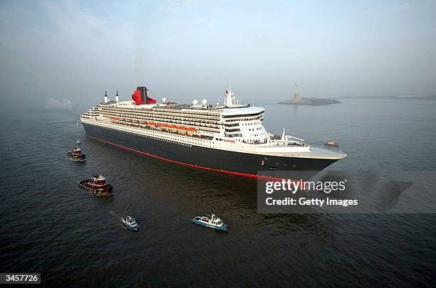 The Queen Mary II, the largest cruise ship in the world, makes her way past the Statue of Liberty on her maiden voyage April 22, 2004 in New York...