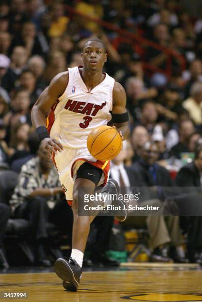 Dwyane Wade of the Miami Heat moves the ball up court during the game against the New Orleans Hornets in Game One of the Eastern Conference...