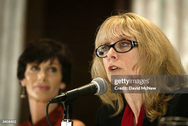 Porn actress Nina Hartley speaks as former porn actress and co-founder of AIM HealthCare Foundation, Dr. Sharon Mitchell , looks on during an AIM...