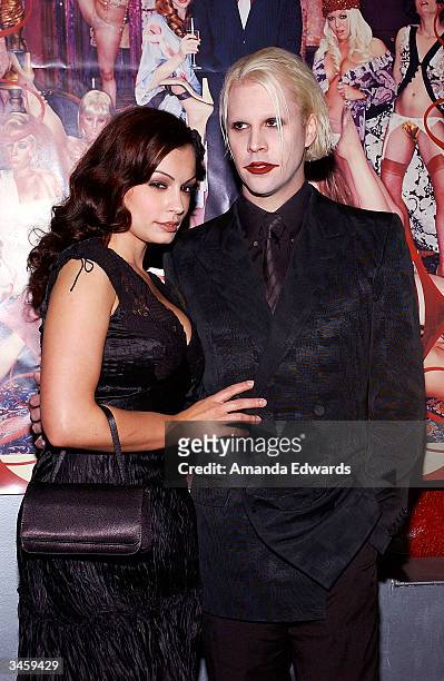 Guitarist John 5 and model Aria Giovanni arrive at the record release party for Gene Simmons' "Asshole" on April 22, 2004 at the Key Club in West...