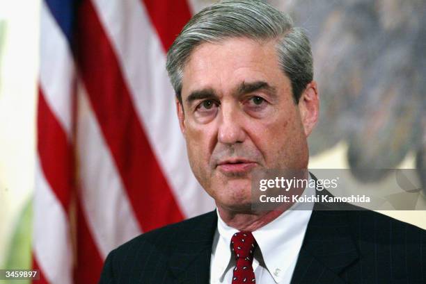 Director Robert Mueller speaks at a press conference at the U.S. Embassy April 23, 2004 in Tokyo. Mueller is on a three day visit to Japan to discuss...