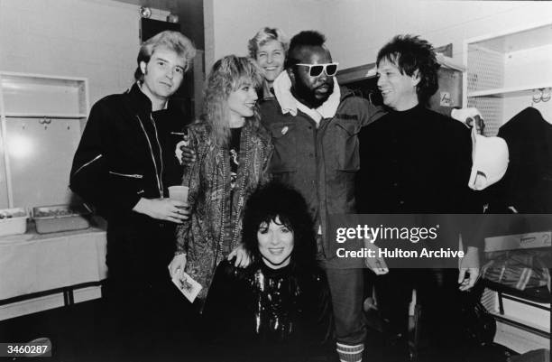 Members of the rock group Heart including Howard Leese, Nancy Wilson, Mark Andes, Denny Carmassi and Nancy Wilson pose for a picture with actor Mr.T...