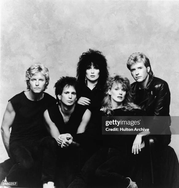 Promotional portrait of the rock group Heart, including: Mark Andes, Denny Carmissi, Ann Wilson, Nancy Wilson and Howard Leese, circa 1980s.