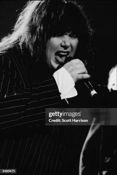 Portrait of American musician and singer Ann Wilson of the rock group Heart singing onstage, 1995.