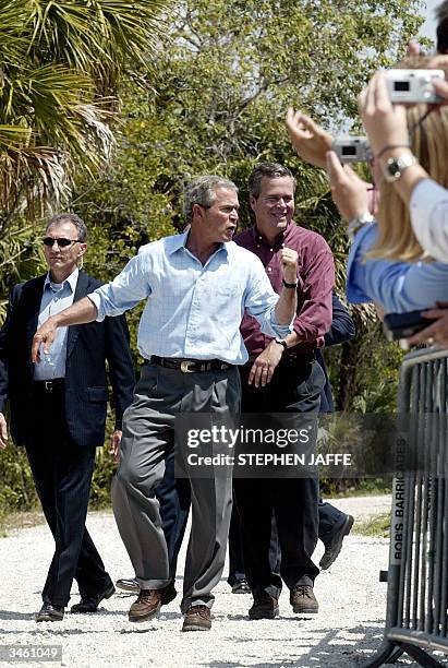 President George W. Bush and his brother Florida Governor Jeb Bush walk to the stage to speak at the Rookery Bay National Estuarine Research Reserve,...