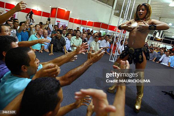 Visitors watch a strip-tease show during Erotika Fair, in Sao Paulo, Brazil, late 22 April 2004. The event, the biggest of its kind in Latin America...