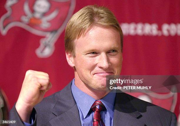 Jon Gruden celebrates as he is introduced as the new head coach of the Tampa Bay Buccaneers at a press conference, Tampa, Florida, February 20, 2002....
