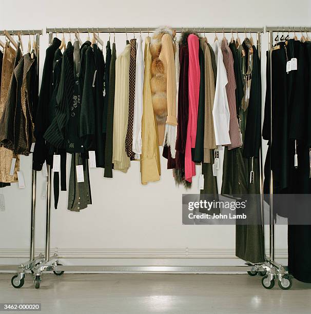 clothing hanging on store rack - 衣服掛け ストックフォトと画像