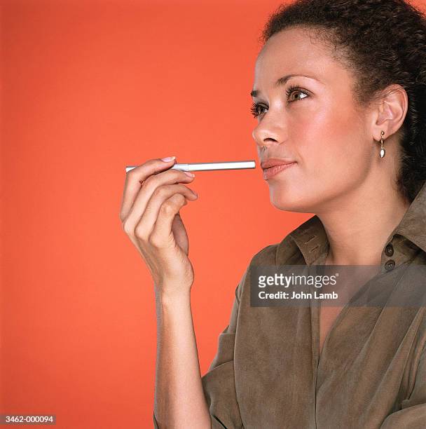 woman thinking - holding pen in hand stock pictures, royalty-free photos & images