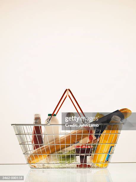 groceries in shopping basket - basket stock pictures, royalty-free photos & images