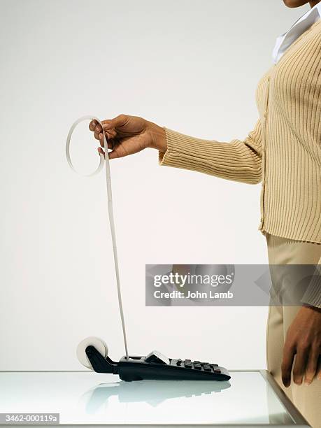 woman holding receipt - 計算機ロールペーパー ストック�フォトと画像