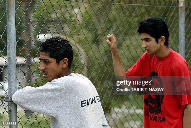 Turkish Cypriots look through a fence to the Greek part of the island on referendum day, 24 April 2004 in Morphou. Turkish Cypriots are to cast their...