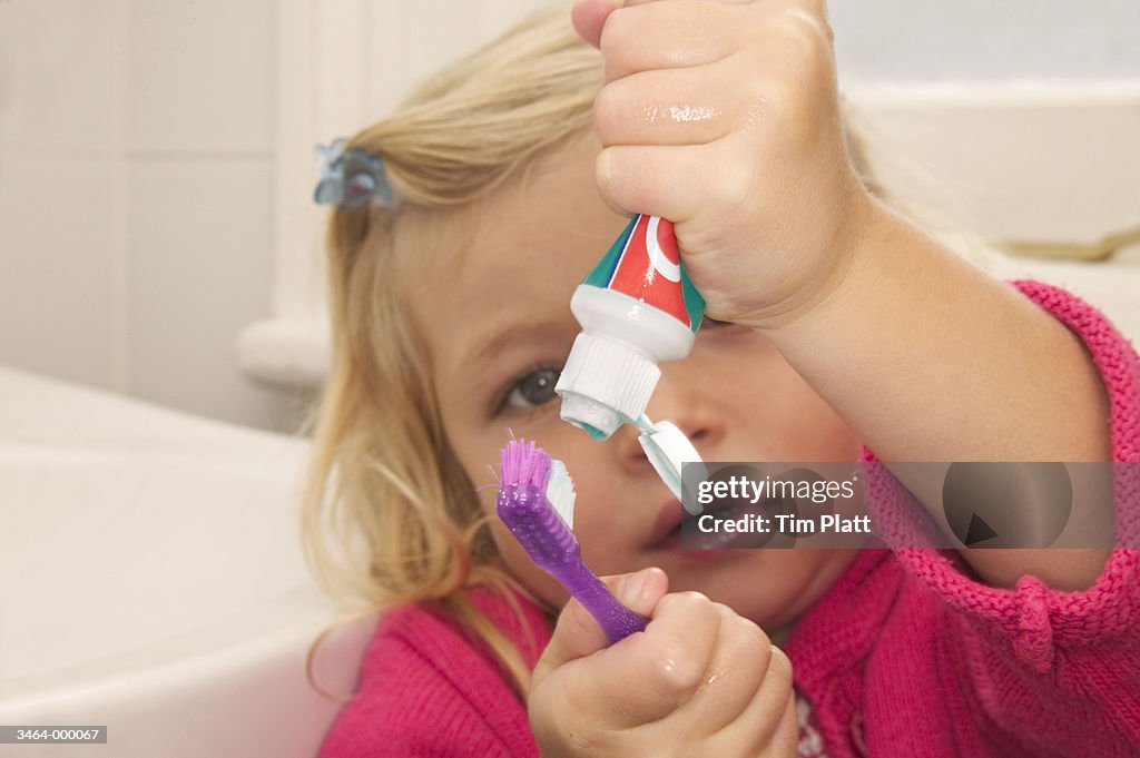 Girl Squeezing Toothpaste