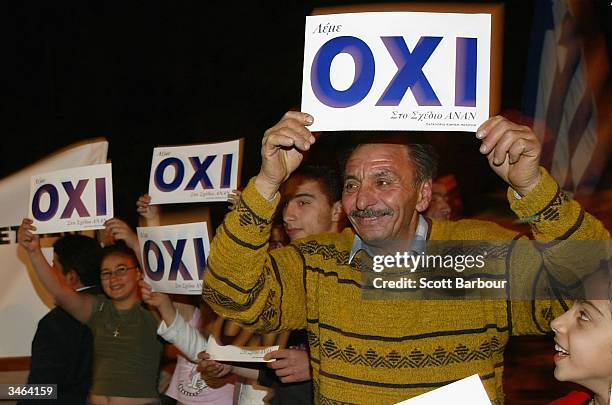 Greek Cypriots celebrate holding 'OXI' or 'NO' signs on April 24, 2004 in Nicosia, Cyprus. Greek and Turkish Cypriots voted in twin referendums on...