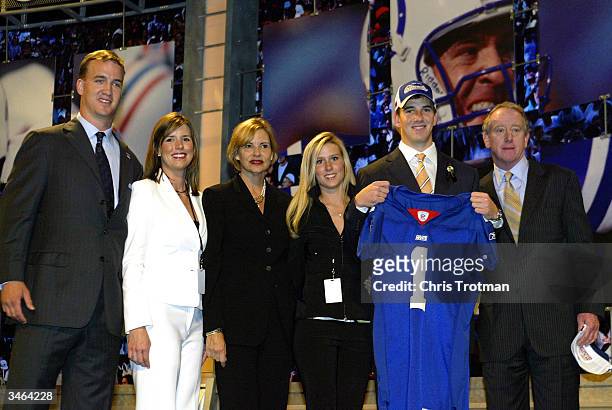 Eli Manning holding a New York Giants jersey and his family including Colts quarterback Peyton Mannng and father Archie Manning during the 2004 NFL...