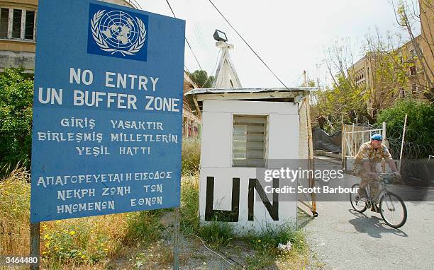 United Nations worker rides his bike through the UN Buffer Zone that seperates the Turkish and Greek sides of Nicosia on April 24, 2004 in Nicosia,...