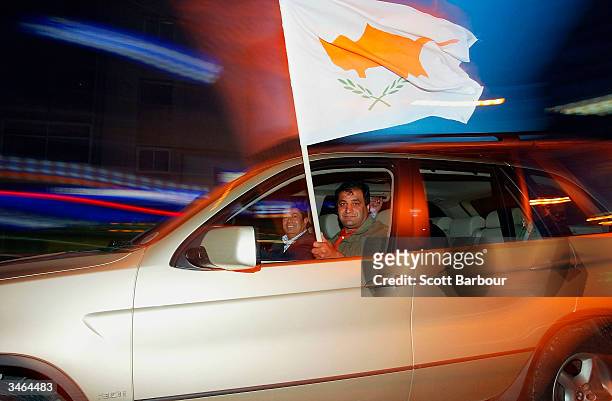 Greek Cypriots wave the flag of Cyprus as they drive down the street after the final results of the referendum on April 24, 2004 in Nicosia, Cyprus....