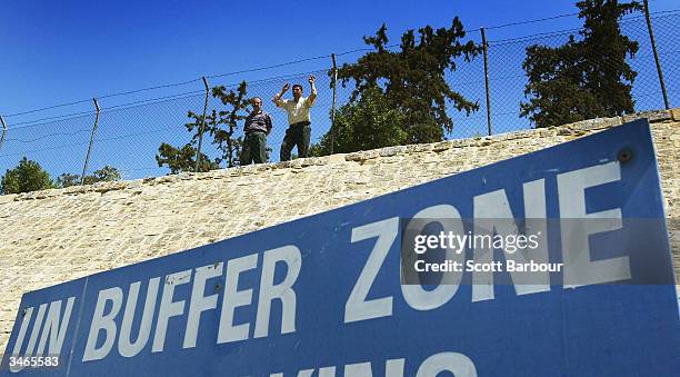 Turkish Cypriots look over the UN Buffer Zone into the Greek part of the divided city of Nicosia from the Turkish side on April 25, 2004 in Nicosia,...