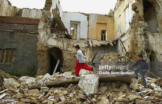 Turkish Cypriot children play in the ruins of a Greek Orthodox Church in the Turkish side of the divided city of Nicosia on April 25, 2004 in...