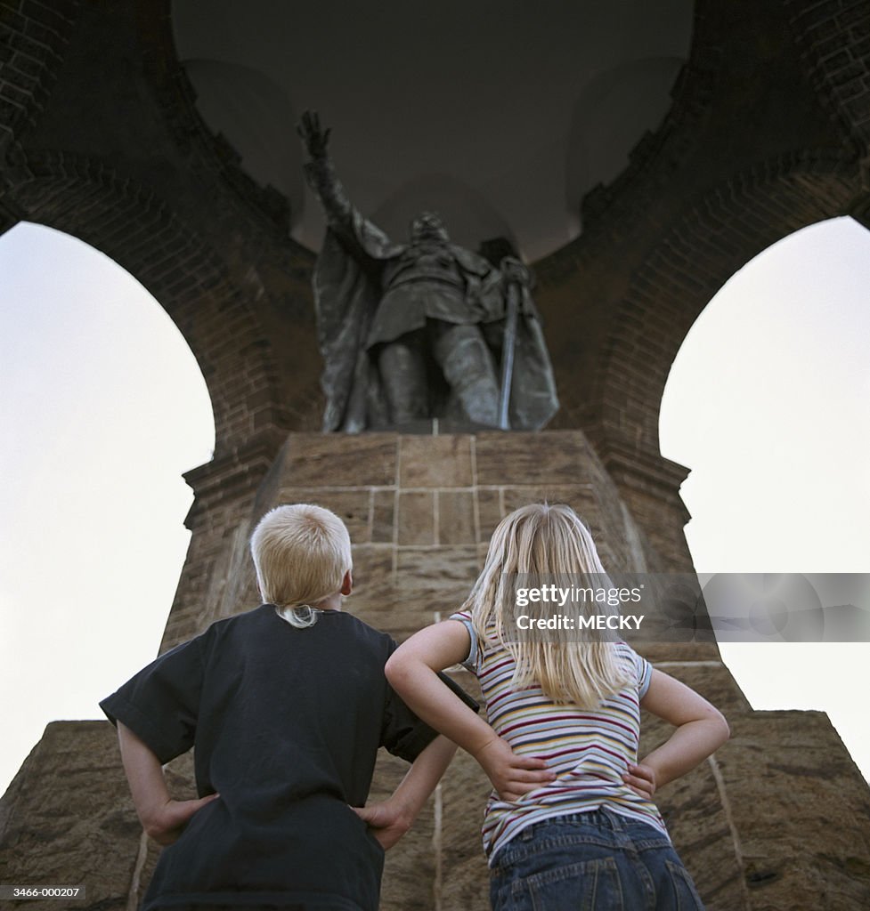 Children Looking at Statue