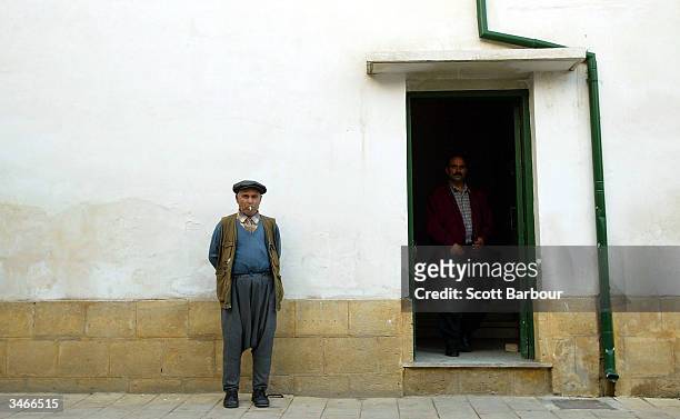 Turkish Cypriot men discuss the outcome of the referendum in the Turkish side of the divided city of Nicosia April 25, 2004 in Nicosia, Cyprus. Greek...
