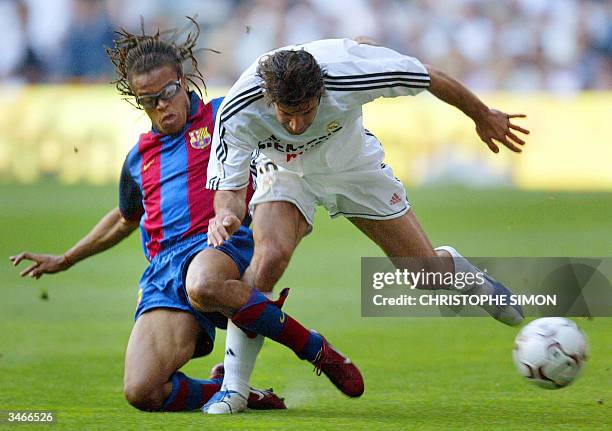 Real Madrid's Portugese Luis Figo fights for the ball with FC Barcelona's Dutch Edgar Davids during the spanish first league football match Real...