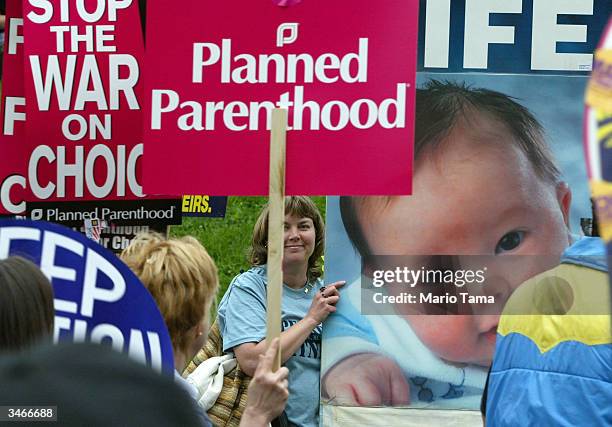 Pro-life activist Patti Frederick of Carrolltown, Pennsylvania displays a giant baby poster as pro-choice demonstrators take part in the March For...