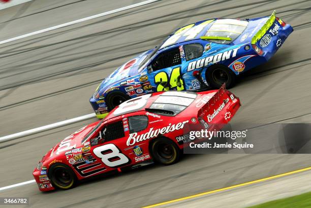 Jeff Gordon, driver of the Hendrick Motorsports Chevrolet, races alongside Dale Earnhardt, Jr., driver of the Budweiser Chevrolet, in the final laps...