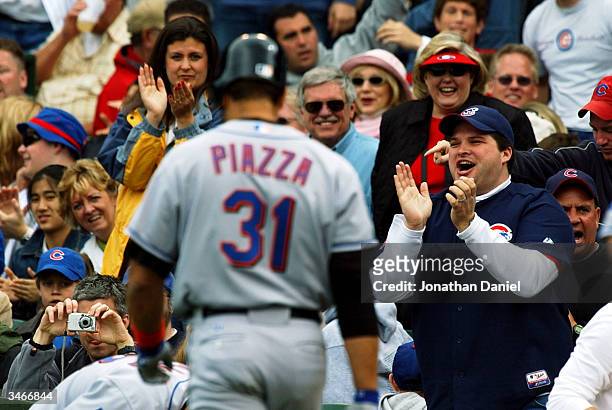 Chicago Cubs' fans react as catcher Mike Piazza of the New York Mets heads to the dugout after striking out against pitcher Matt Clement on April 25,...