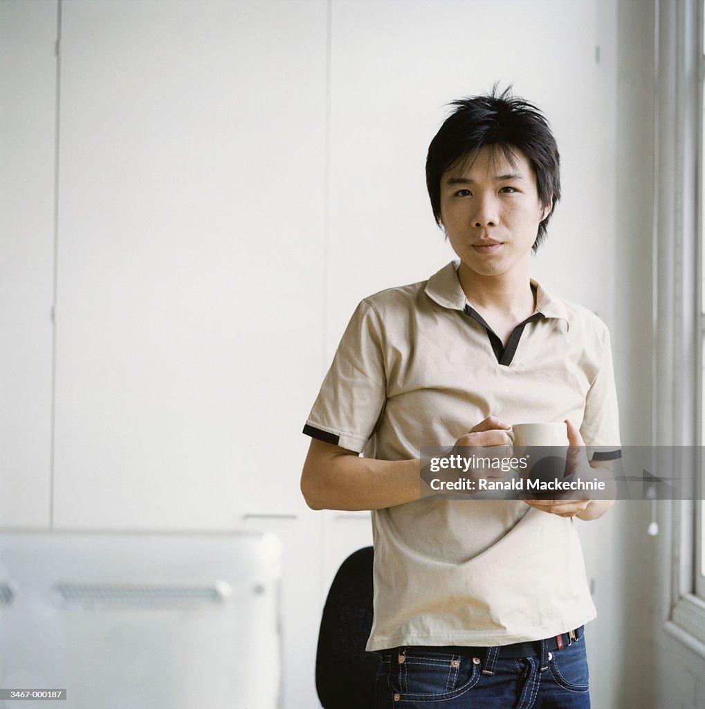 Young Man with Coffee Cup