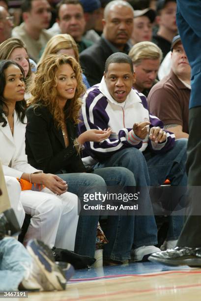 Hip-hop artists Beyonce and Jay-Z sit courtside during Game four of the Eastern Conference Quarterfinals of the 2004 NBA Playoffs between the New...