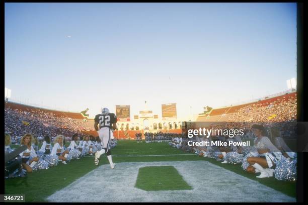 Defensive back Mike Haynes of the Los Angeles Raiders runs onto the field before a game against the San Francisco 49ers at the Coliseum in Los...