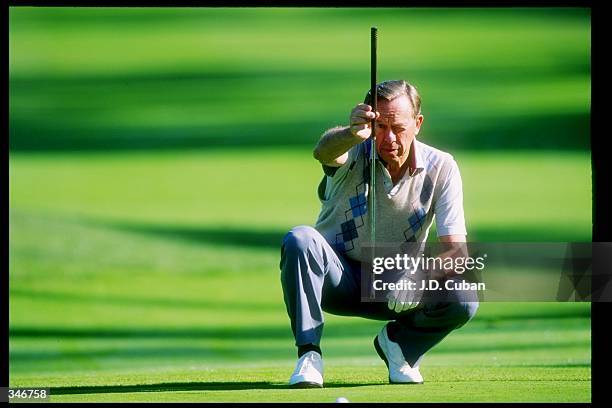 Former NASA astronaut Alan Shephard lines up a shot during a golfing event. Mandatory Credit: J. D. Cuban /Allsport