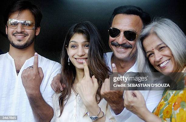 Bollywood actor, Vivek Oberoi, his sister, Meghna, father, Suresh Oberoi and his wife show their fingers with the ink mark after voting at a polling...