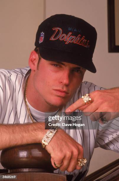 White rapper Vanilla Ice wearing a Miami Dolphins cap, a diamond bracelet and an assortment of rings, circa 1990.