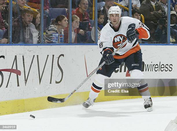 Dave Scatchard of the New York Islanders passes the puck behind the net against the St. Louis Blues on March 9, 2004 at the Savvis Center in St....