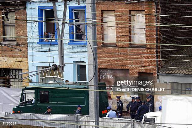 Belgium policemen stand in front of the house of child rapist Marc Dutroux in Marcinelle, a suburb of the southern Belgian city of Charleroi, 27...