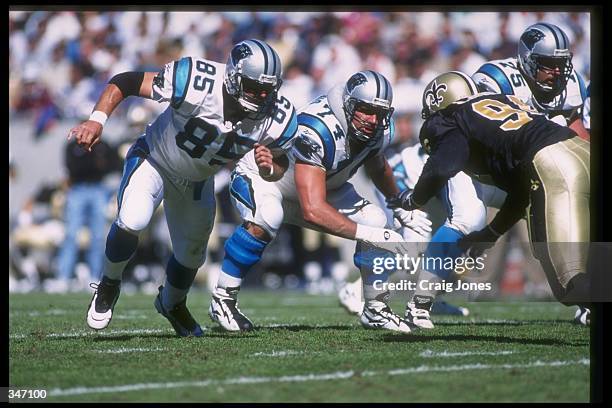 Tight end Wesley Walls of the Carolina Panthers looks to block a New Orleans Saints player during a game at Ericsson Stadium in Charlotte, North...