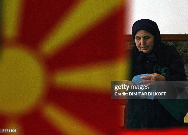 An elderly internally displaced woman votes for the second round of Macedonian presidential elections in Skopje, 27 April 2004. Members of the armed...